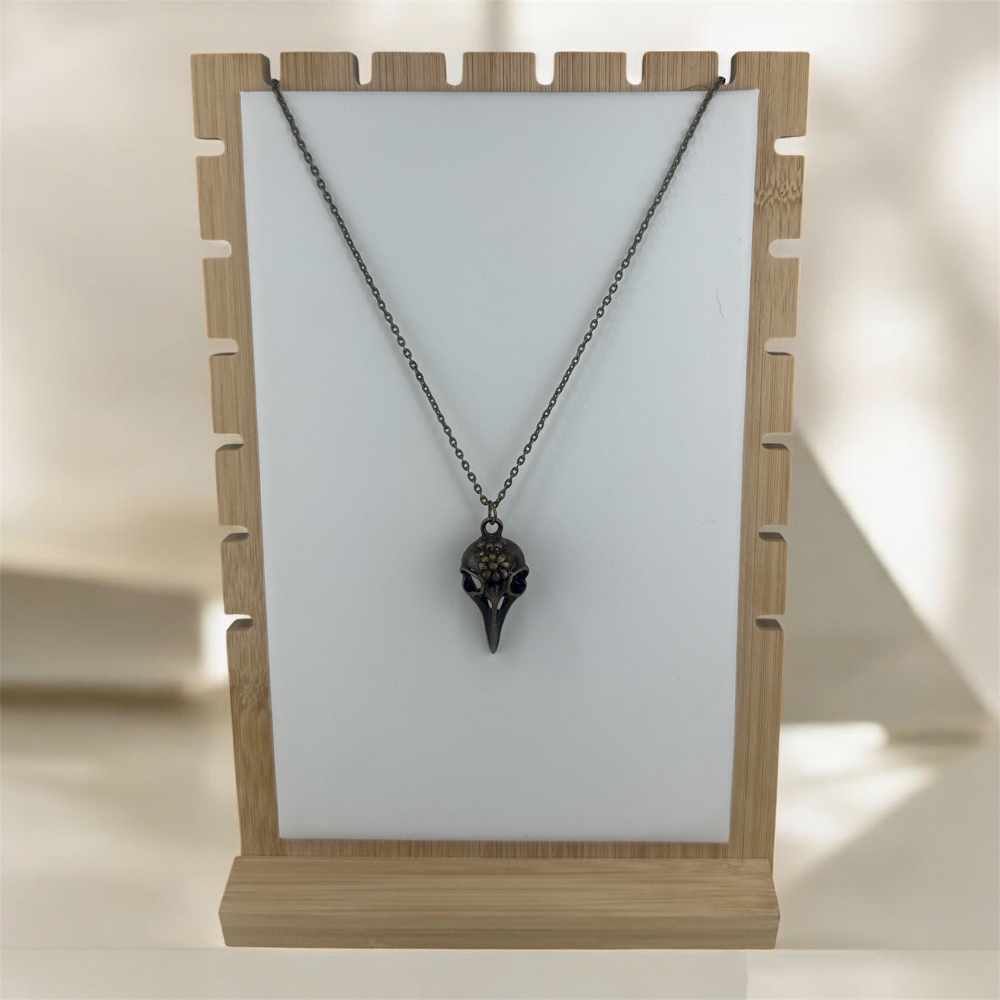 Bronze bird skull necklace